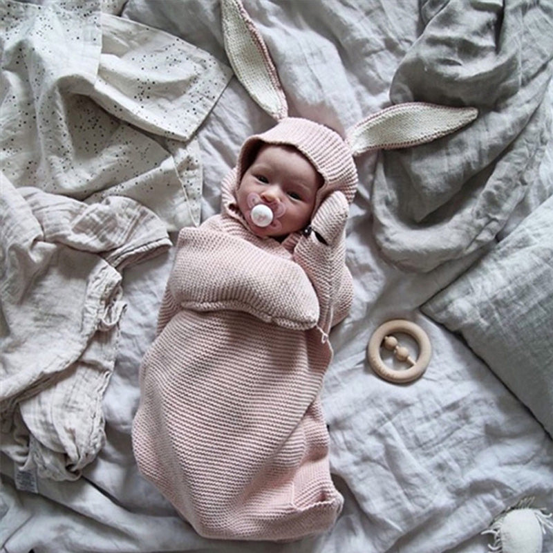 Small baby in a pink bunny style sleeping bag